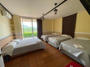 HOTEL CAMPESTRE MANOA客房内的一张或多张床位