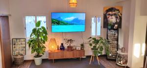 a living room with a tv hanging on a wall at Caparica Villa in Almada