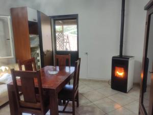 a dining room with a table and a wood stove at Lorenzo B&B in Olevano sul Tusciano