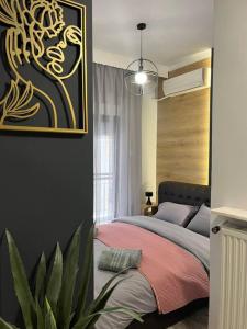 a bedroom with a bed with a painting on the wall at Central 4 Modern Apartment with parking in Serres