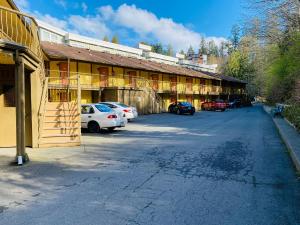 een gebouw met auto's geparkeerd op een parkeerplaats bij Wessex Inn By The Sea in Cowichan Bay