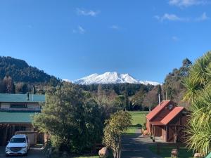 a snow covered mountain in the distance behind a house at Ridley Manor in Ohakune