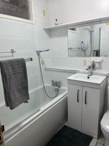 uma casa de banho com uma banheira, um lavatório e um WC. em LONDON 1 BED COSY HOUSE em Norwood