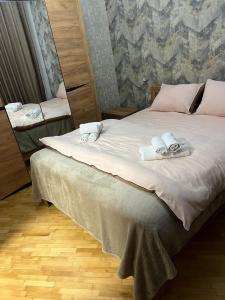 a bedroom with a bed with towels on it at S-Nova in Gyumri