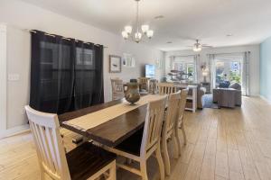 a dining room and living room with a wooden table and chairs at Arborgate Gate Away At 7971 Double Gate Dr By Pkrm in Pensacola