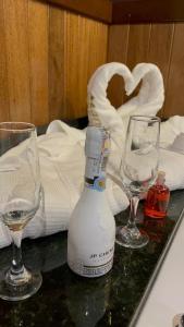 two empty wine glasses and a bottle on a table at HOTEL CAMPESTRE MANOA in Rivera