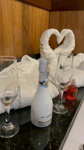 里韦拉HOTEL CAMPESTRE MANOA的两杯空酒杯和一张桌子上的瓶子