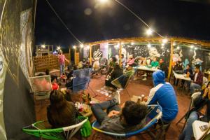 a group of people sitting in chairs at a party at Gente de Más Hostel in Puebla