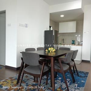 a dining room table and chairs in a kitchen at Sunrise Homestay Vista Bangi in Kajang
