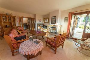 ein Wohnzimmer mit Sofa, Stühlen und einem Tisch in der Unterkunft Casa Surya - unique country house near Granada in Nigüelas