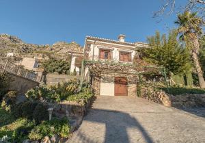 una casa con una entrada que conduce a un garaje en Casa Surya - unique country house near Granada, en Nigüelas