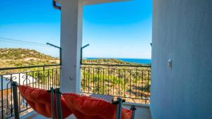 a balcony with a hammock and a view of the ocean at VİLLA TANYERİ in Kas