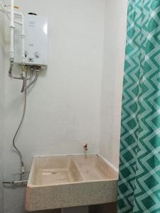 a bathroom with a sink in a room at Hogar Dulce Hogar in Cancún