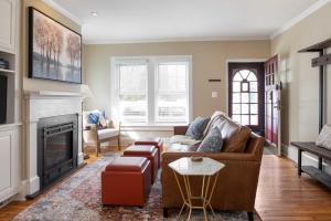a living room with a couch and a fireplace at Charming Brooke House with Patio - In Town! in Lambertville