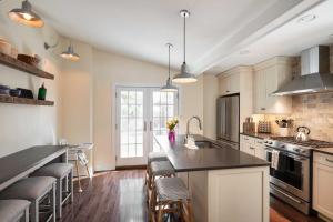a kitchen with white cabinets and a black counter top at Charming Brooke House with Patio - In Town! in Lambertville