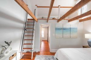 a bedroom with white walls and wooden beams at Charming Brooke House with Patio - In Town! in Lambertville