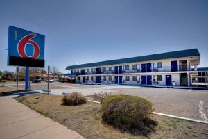 a building with a sign in front of a parking lot at Motel 6-Douglas, AZ in Douglas