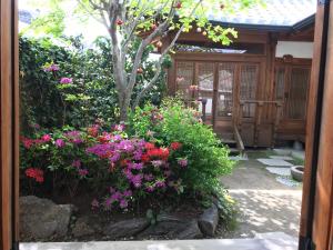 a garden with flowers in front of a building at Sarangroo in Jeonju