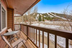 a balcony with a table and chairs and a snow covered mountain at 2401 Pitchfork in Jackson