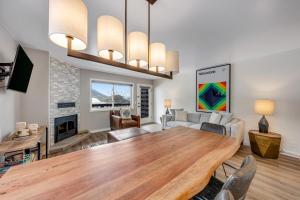 a living room with a wooden table and a fireplace at 2401 Pitchfork in Jackson