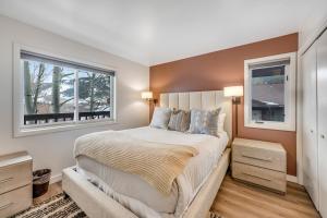 a bedroom with a large bed with two windows at 2401 Pitchfork in Jackson
