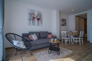 a living room with a couch and a table at Tisno Laurel Apartments in Tisno