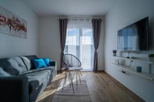a living room with a couch and a window at Tisno Laurel Apartments in Tisno