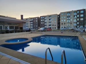 a large swimming pool in front of a building at Departamento full equipado in Temuco