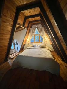 a bedroom with a large bed in an attic at del ANDINO.USH in Ushuaia