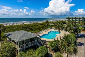 an aerial view of a resort with a pool and a beach at Sea Cabin 306-A in Isle of Palms