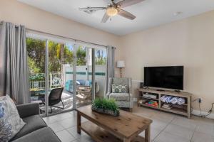 a living room with a flat screen tv and a couch at Palm Villa in Duck Key