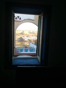 an open window with a view of a building at Omay ka in Aswan