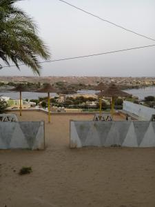 a beach with two concrete benches in the sand at Omay ka in Aswan