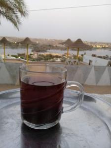 a cup of coffee sitting on a table at Omay ka in Aswan