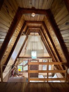 a view from the attic of a cabin with a window at del ANDINO.USH in Ushuaia