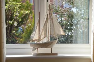 a model boat sitting on a window sill at The West Wick House in Weston-super-Mare