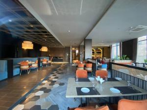 a dining room with tables and chairs in a restaurant at Tara Luxury Homes in Solan