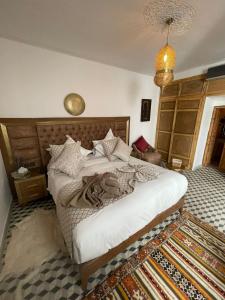 a bedroom with a bed in a room with a rug at Riad Le Grizzly in Marrakesh +127 photos