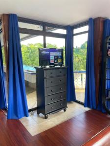 a room with a computer on a dresser in front of a window at Ngermid Oasis- 1BD, Beautiful Lodge, Amazing Views in Koror