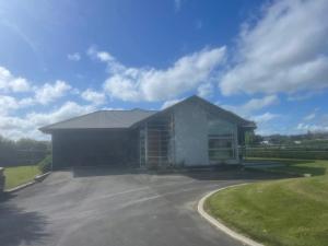 a large white building with a driveway at Benrose Park in Palmerston North