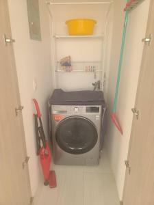 uma máquina de lavar roupa num pequeno quarto com uma ferramenta em Suite Chipipe AC Wi-Fi Lavanderia a 1 cuadra mar em Salinas