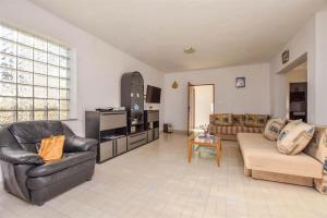 a large living room with couches and a tv at Seaside holiday house Banj, Pasman - 21126 in Ždrelac