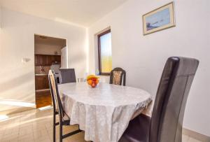 a dining room table with a white table cloth on it at Seaside holiday house Banj, Pasman - 21126 in Ždrelac
