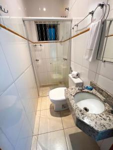 a bathroom with a sink and a toilet at Hotel Savana in Olímpia