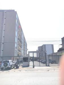a car parked next to a fence in a city at 821 Céntrico Departamento en Chorrillos in Lima