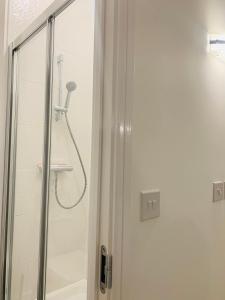 a shower with a shower head in a bathroom at Deluxe En suite Bedroom with free on site parking in Milton Keynes