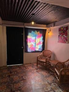 a room with two chairs and a projection screen at Casa Ausa - Bacnotan La Union in Bacnotan