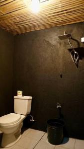 a bathroom with a toilet and a camera on the wall at Casa Ausa - Bacnotan La Union in Bacnotan