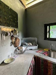 a kitchen counter with a sink and a plate on it at Casa Ausa - Bacnotan La Union in Bacnotan