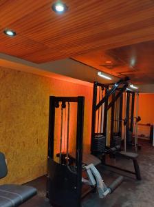 a gym with two tread machines in a room at Distrito A FMA-Coliving in Salta